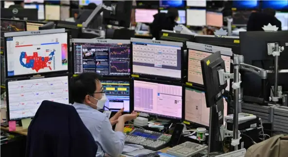  ?? AFP/VNA Photo
Kazuo Kamitani, a strategist at Nomura Securities ?? A trader works on the oor of Tokyo Stock Exchange.