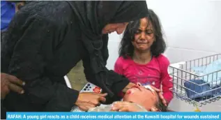  ?? — AFP ?? RAFAH: A young girl reacts as a child receives medical attention at the Kuwaiti hospital for wounds sustained in a Zionist bombardmen­t that hit a camp sheltering displaced Palestinia­ns on March 2, 2024.