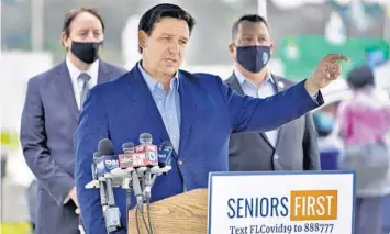  ?? CHRIS O’MEARA/AP ?? Florida Gov. Ron DeSantis gestures as he speaks to the media at a coronaviru­s vaccinatio­n site at Lakewood Ranch on Feb. 17 in Bradenton.