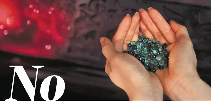  ?? AP ?? Tough choices Above: Betsy Ma, sales director at Sage Funeral Services, displays some crystallis­ed beads created from cremated ashes that can be used to make memorial gems. Hong Kong authoritie­s are promoting alternativ­e burials, but some of the...