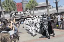  ?? PHOTO BY PRESTON MACK ?? At various times each day, the menacing Captain Phasma leads a squad of First Order stormtroop­ers as they march from “Star Wars” Launch Bay to the Center Stage area at Disney’s Hollywood Studios.