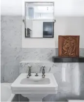  ??  ?? BATHROOM A terracotta bas-relief plaque by 20th-century French sculptor René Iché provides a striking contrast to the cool marble tones in this timeless scheme.
FS washbasin, £780, Czech & Speake. Arcade swivel mirror, £249, Drench, is similar