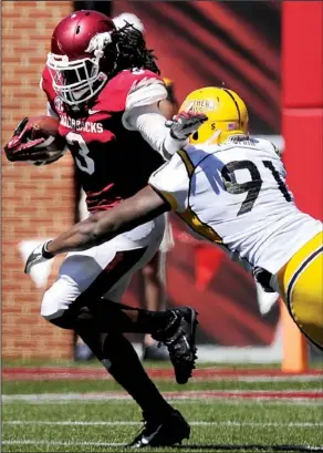  ?? NWA Media/BEN GOFF ?? Arkansas running back Alex Collins tries to get away from Southern Miss defender Michael Smith in the second half Saturday at Reynolds Razorback Stadium in Fayettevil­le. Collins rushed for more than 100 yards for the third time this season in the...