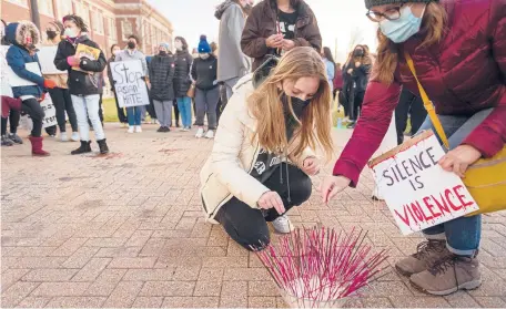  ?? MARK MIRKO/HARTFORD COURANT ?? Incense is lit in West Hartford in March in memory of six women of Asian descent who were killed in Atlanta. Event speakers recounted troubling experience­s with anti-Asian attitudes, and others spoke of the need for solidarity against racism between people of color.