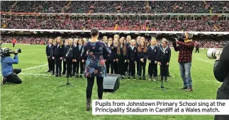  ?? ?? Pupils from Johnstown Primary School sing at the Principali­ty Stadium in Cardiff at a Wales match.