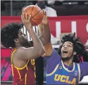  ?? Mark J. Terrill Associated Press ?? USC’S ETHAN ANDERSON, left, battles UCLA’s Tyger Campbell in a Pac-12 meeting last season.