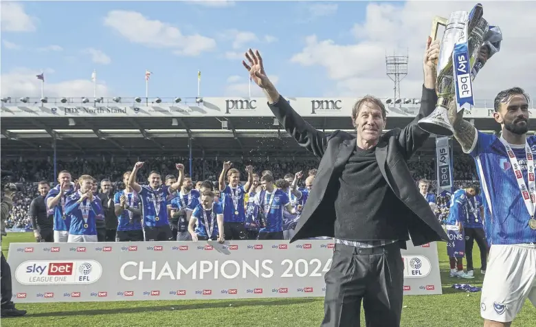  ?? ?? We are the champions – Pompey director Eric Eisner and skipper Marlon Pack lift the League One trophy at Fratton Park last weekend