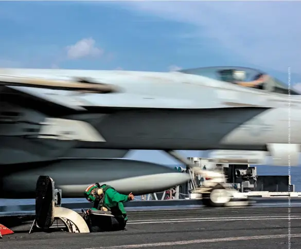  ??  ?? GLOBAL TRAINING Top: A catapult on the deck of the aircraft carrier USS Abraham Lincoln. Bottom, from left: A Russian serviceman during a shooting exercise; Marines unwinding after training operations in Finland; commanders from the U.S., U.K., Finland and Estonia getting awards for training service.