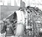  ?? NATIONAL TRANSPORTA­TION SAFETY BOARD VIA GETTY IMAGES ?? Investigat­ors examine the damaged Southwest jet.