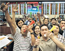  ??  ?? Ending on a high: traders celebrate 2017’s last day of action on the Philippine stock exchange in Manila. Equity markets around the world have enjoyed a strong year, to the delight of investors