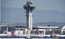  ?? Airport. Photograph: Caroline Brehman/EPA ?? American Airlines planes taxi around the air traffic control tower at Los Angeles internatio­nal