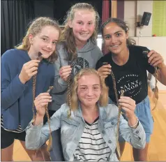  ??  ?? DONATION: Zyla Neslon, centre, with Izabel White, Chanel Scollary and Maddy Toet, show off her cut locks.Pictures: PAUL CARRACHER