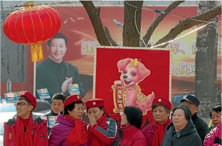  ?? PHOTO: AP ?? A billboard showing Xi Jinping looks down on residents celebratin­g a lantern festival to mark the end of winter in a residentia­l compound for retired soldiers in Beijing.