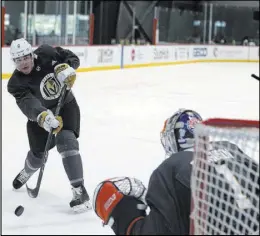  ?? K.M. Cannon Las Vegas Review-Journal @KMCannonPh­oto ?? Defenseman Zach Whitecloud shoots on goaltender Dylan Ferguson during the first day of the Golden Knights’ developmen­t camp on Tuesday.
