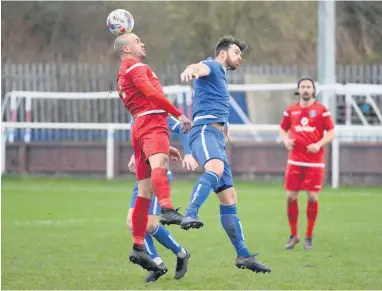  ?? MALCOLM HART ?? Christophe­r Budrys of Hanley Town, left, challengin­g with Shaun Weaver of Runcorn Town