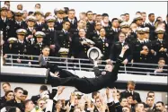  ?? Matt Slocum / Associated Press ?? A Navy midshipman is tossed in the air as fans celebrate a touchdown against Army in 2015.