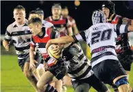  ??  ?? Crowded out No space for Josh Henderson with Heriot’s defenders all around him