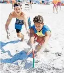  ?? GARY CURRERI/CORRESPOND­ENT ?? Pompano Beach junior lifeguard Christian Quinones, right, lunges for the beach flag ahead of Hollywood Fire Rescue and Beach Safety junior lifeguard Luke Valenchis to take the title in that Boys B Division event at the James P. “Mac” McCarthy Memorial...