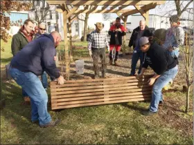  ?? EVAN BRANDT — MEDIANEWS GROUP ?? The second of two benches donated by the Pottstown Police Officers Associatio­n is installed at the Native American memorial site on South Franklin Street on Dec. 23.