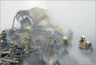  ?? Picture: AFP ?? AIR CRASH HORROR: Rescue personnel work at the crash site in the village of Dacha-Suu outside Bishkek yesterday