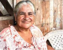  ??  ?? Brigida Gonzalez sits on her porch in the peace community. Her daughter was murdered in 2005 by the military