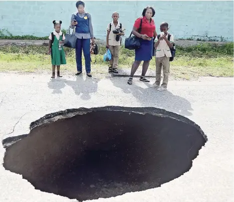  ?? KENYON HEMANS ?? This was the scene on John Golding Road in St Andrew in May after the road collapsed. Taxi operators are livid that the road has not been fixed.