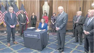  ??  ?? US House Speaker Nancy Pelosi, centre, speaks during the signing ceremony of the ‘Cares’ Act in Washington last week.