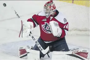  ?? RYAN MCLEOD ?? Stuart Skinner makes a save as the Calgary Hitmen took on the Lethbridge Hurricanes at the Saddledome in March.