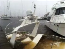  ?? ALLEN G. BREED — THE ASSOCIATED PRESS ?? The mast of a sunken boat sits at a dock at the Grand View Marina in New Bern, N.C., on Friday. Winds and rains from Hurricane Florence caused the Neuse River to swell, swamping the coastal city.