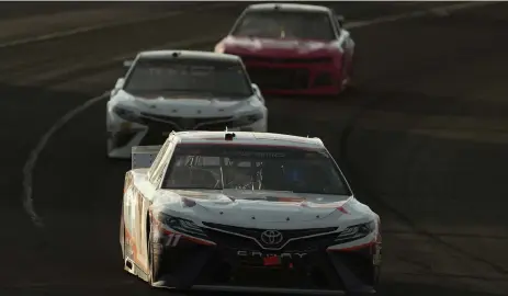  ?? Patrick Smith, Getty Images ?? Denny Hamlin leads a pack of cars during the NASCAR Cup Series Pocono 350 at Pocono Raceway on Sunday in Long Pond, Pa.