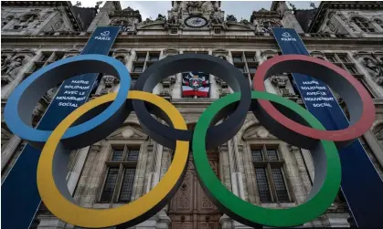  ?? ?? The Olympic rings in front of Paris city hall; Russian and Belarusian athletes will have to sign a statement promising to respect the Olympic Charter. Photograph: Aurélien Morissard/AP