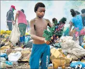  ?? AFP/FILE ?? The picture of Gabriel Silva, holding a Christmas decoration at the Picarreira landfill in Pinheiro, which went viral.