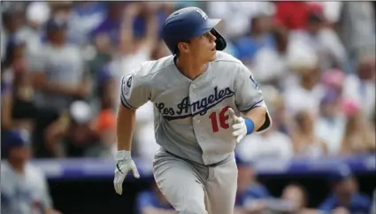  ??  ?? Los Angeles Dodgers’ Will Smith watches his three-run home run off Colorado Rockies’ Wade Davis during the ninth inning of a baseball game on Wednesday in Denver. The Dodgers won 5-1. AP PHOTO/DAVID ZALUBOWSKI