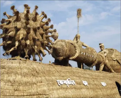  ?? GETTY IMAGES ?? The all-too familiar spike protein of the virus behind COVID-19 is represente­d in a traditiona­l community creation on Jan 15 for the Bhogali Bihu festival in the Indian state of Assam.