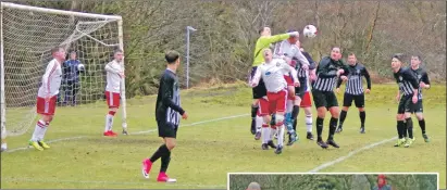  ?? Match report and photos: Derek Black ?? Saints keeper Graham Douglas punches the ball clear during a second-half Yoker attack.