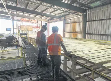  ?? KAREN E. SEGRAVE — THE NEW YORK TIMES ?? Workers feed boards through a planer at Resolute Forest Products in El Dorado, Ark. The housing-and-renovation boom drove insatiable demand for lumber, even as the pandemic idled mills already slowed by an anemic constructi­on sector.