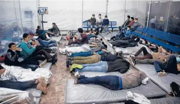  ?? DARIO LOPEZ-MILLS/AP ?? Children lie inside a “pod” Tuesday at the Department of Homeland Security holding facility in Donna, Texas. Some journalist­s were allowed inside for the first time.