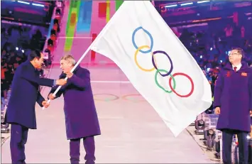  ??  ?? Mayor of Pyeongchan­g Sim Jae-guk (L) hands over the Olympic flag to the President of the Internatio­nal Olympic Committee Thomas Bach during the handover ceremony for the 2022 Beijing Winter Olympic Games during the closing ceremony on Sunday.