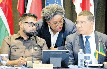  ?? PHOTOS BY RICARDO MAKYN/CHIEF PHOTO EDITOR ?? Dr Mohamed Irfaan Ali, president of the Cooperativ­e Republic of Guyana and chairman of the Conference of CARICOM Heads of Government, speaks with the prime ministers of Jamaica, Andrew Holness (right) and Barbados, Mia Mottley, during yesterday’s high-level CARICOM meeting on Haiti at The Jamaica Pegasus hotel in New Kingston.