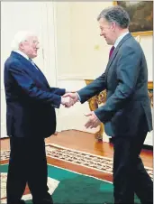  ??  ?? President Michael D Higgins greets the former President of Colombia, Juan Manuel Santos, after he received the 2017 Tipperary Peace Award.