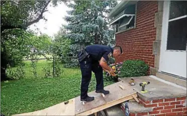  ?? SUBMITTED ?? Euclid Police Officer James Aoki built a temporary wheelchair ramp for a Euclid resident after responding to a call where she reported the metal ramp she used to get in and out of her house had been stolen.