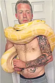  ?? Picture: INS ?? Dan Brandon, 31, posing with one of his snakes