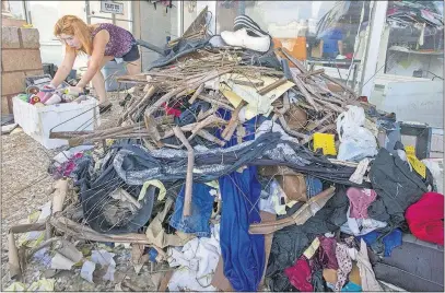  ?? [STUART VILLANUEVA/THE GALVESTON COUNTY DAILY NEWS] ?? Ngoc Nguyen faces a big cleanup at the store she runs, Willis Tailor and Alteration­s in Dickinson, Texas, after flooding brought on by Hurricane Harvey. Other U.S. coastal cities could be face similar damage if they took a direct hit from a hurricane.