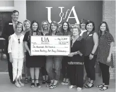  ?? Submitted photo ?? ■ The University of Arkansas at Hope-Texarkana recently establishe­d the Junior Auxiliary Kat Young Endowed Scholarshi­p in honor of one of the charter members of the JA in Hope, Ark. Front row, from left: Kari Rohrbaug, Anna Powell, Megan Cox, Kat Young, Mary Berry and Lindsey Townsend. Back row, from left: UA Hope-Texarkana Chancellor Chris Thomason, Marlon Ward, Mikki Curtis, Lauren Hill and Betsy Still.