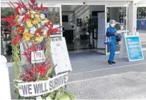  ?? WILFREDO LEE/AP ?? A flower arrangemen­t is shown at an entrance of Jackson Memorial Hospital, Monday in Miami.