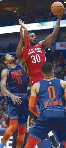  ?? AP ?? New Orleans Pelicans center Julius Randle shoots over Oklahoma City forward Paul George (13) in an NBA game in New Orleans.