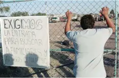  ?? — AFP ?? People demand to be allowed to enter the area damaged by an explosion the day before at a fireworks market in Tultepec, a suburb of Mexico City, to search for their family members on Wednesday.