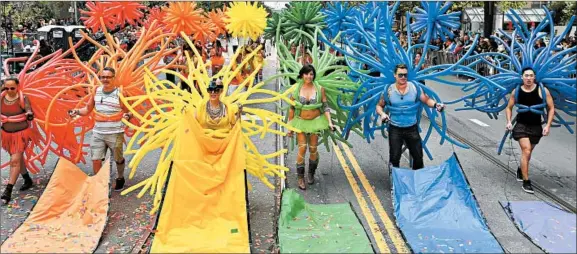  ?? GETTY ?? People march with banners and balloons during the 2017 San Francisco Pride Parade, one of the country’s oldest and largest pride events.