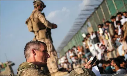  ?? Photograph: Ben Shread/Ministry of Defence/AFP/Getty Images ?? British military at Kabul airport. Afghans who protected Australia’s embassy and families with visas have spent days on the crowded, dangerous road unable to get inside.