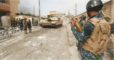  ?? (Azad Lashkaril/Reuters) ?? AN IRAQI soldier is pictured during a battle with Islamic State in western Mosul yesterday.